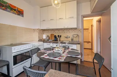 a kitchen with a table and chairs in a kitchen at Vivid Condo by NDK and Vitosha Blvd with Free Secured Parking and AC in Sofia