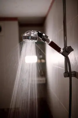 a shower with a water hose attached to a wall at Vivid Condo by NDK and Vitosha Blvd with Free Secured Parking and AC in Sofia