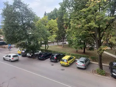 a row of cars parked on the side of a street at стаи за гости TODA in Troyan
