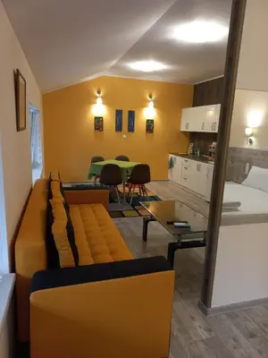 a living room with a couch and a table at стаи за гости TODA in Troyan