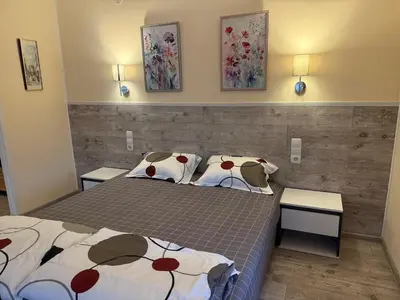 a bedroom with two beds and two tables at стаи за гости TODA in Troyan