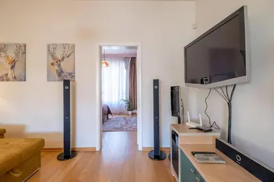 a living room with a large flat screen tv on a wall at Aristocratic Place, TOP location in Sofia
