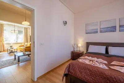 a bedroom with a bed and a living room at Aristocratic Place, TOP location in Sofia