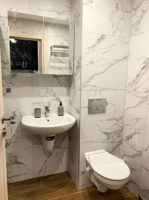 a white bathroom with a sink and a toilet at Cozy Riverside Pine Studio E5 in Borovets