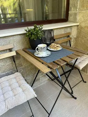 a picnic table with two plates of food and a cup of coffee at Cozy Riverside Pine Studio E5 in Borovets