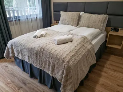 a bedroom with a bed with two towels on it at Cozy Riverside Pine Studio E5 in Borovets