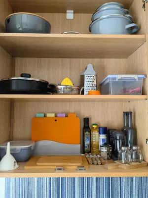 a kitchen shelf with various kitchen items on it at Royal Blue River Pearl in Sandanski