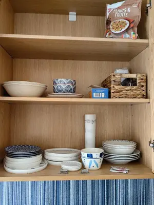 a wooden shelf with plates and bowls on it at Royal Blue River Pearl in Sandanski