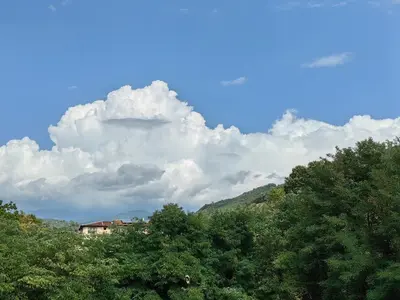 a house on top of a hill with trees at Royal Blue River Pearl in Sandanski