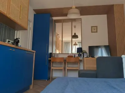 a living room with a blue cabinet and a table at Royal Blue River Pearl in Sandanski