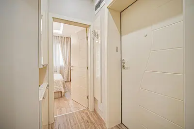 a hallway with a door leading to a bedroom at Cappuccino Dream in Sofia