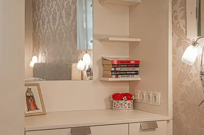 a bedroom with a mirror and a shelf with books at Cappuccino Dream in Sofia
