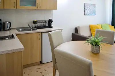 a kitchen with a wooden table and a dining room at Forest view in Pamporovo