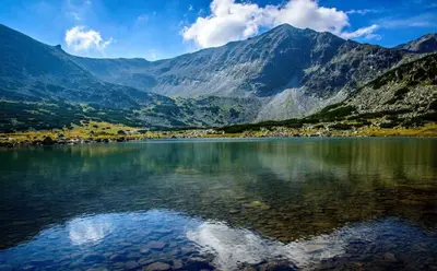 a large body of water with mountains in the background at Spacious studio sleeps 4 in Flora main building 706A in Borovets