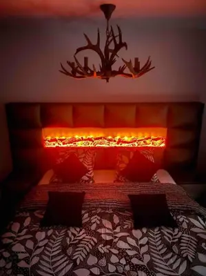 a bedroom with a bed with a light above it at Cosy Appartement Green Life Bansko in Bansko