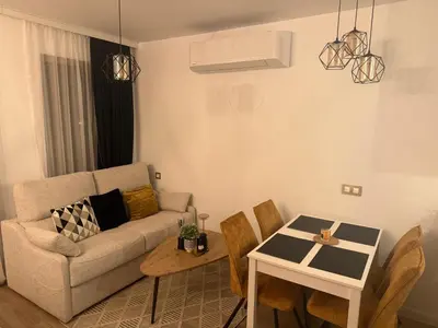 a living room with a couch and a table at Cosy Appartement Green Life Bansko in Bansko