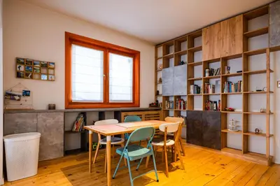a dining room with a wooden table and chairs at Colorful Getaway right next to NDK by Flat Mаnager in Sofia