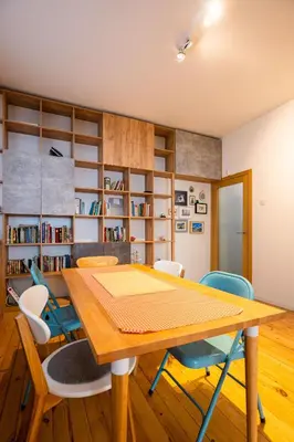 a dining room with a wooden table and chairs at Colorful Getaway right next to NDK by Flat Mаnager in Sofia