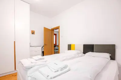 a bedroom with two beds with white sheets at Colorful Getaway right next to NDK by Flat Mаnager in Sofia