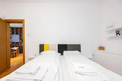 a bedroom with a bed with white sheets at Colorful Getaway right next to NDK by Flat Mаnager in Sofia