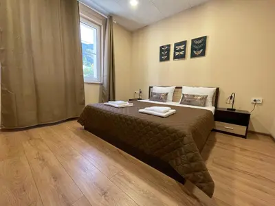 a bedroom with a bed with two towels on it at Forest Oasis Guest House FREE PARKING in Sapareva Banya