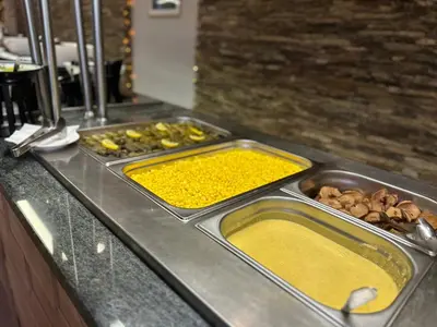 a kitchen counter with two trays of food on it at Hotel Panorama Ski in Pamporovo