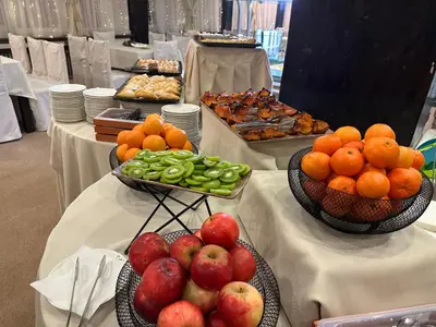 two bowls of apples and oranges and other fruits on tables at Hotel Panorama Ski in Pamporovo
