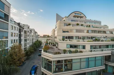 an apartment building with balconies on a city street at Alexandra's City Center Apartment II in Sofia