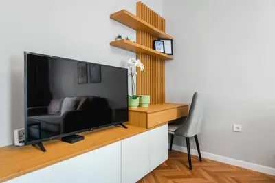 a living room with a large flat screen tv at Lozenets Apartment in Sofia