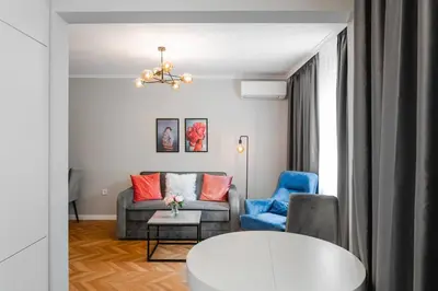 a living room with a couch and a chair at Lozenets Apartment in Sofia