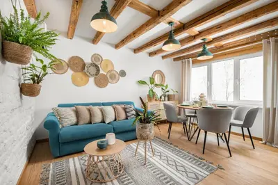 a living room with a blue couch and a table at Alexandra's City Center Apartment III in Sofia