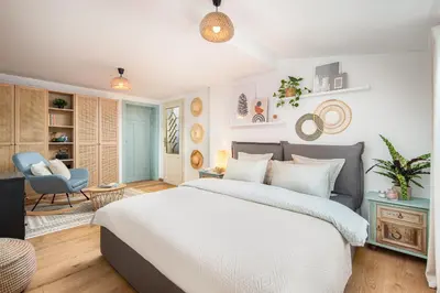 a bedroom with a bed and a living room at Alexandra's City Center Apartment III in Sofia