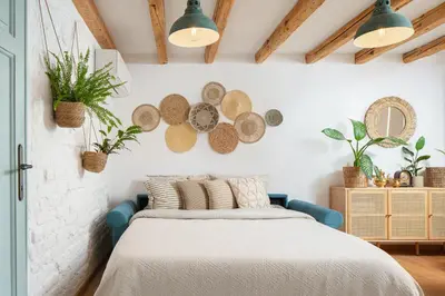 a bedroom with a bed and plates on the wall at Alexandra's City Center Apartment III in Sofia