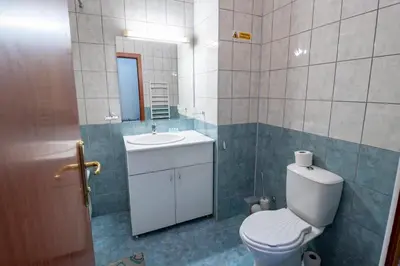 a bathroom with a toilet and a sink and a mirror at Stylish one bedroomed apartment 112 in main Flora building in Borovets