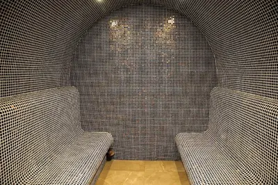 a room with two benches in a tiled wall at Stylish one bedroomed apartment 112 in main Flora building in Borovets