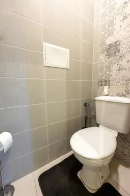 a bathroom with a white toilet in a room at Julie Suite Top Center in Sofia