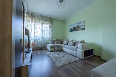 a living room with a couch and a tv at Julie Suite Top Center in Sofia