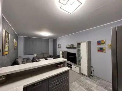 a room with a kitchen with a counter and a refrigerator at Nice new apartment in Sofia