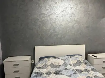 a bedroom with a bed and two night stands at Nice new apartment in Sofia