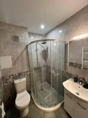 a bathroom with a shower and a toilet and a sink at Nice new apartment in Sofia