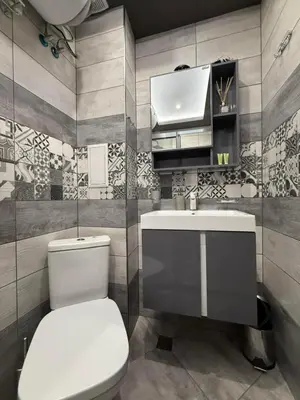 a bathroom with a toilet and a sink at Апартаменти в сърцето на парка in Sandanski