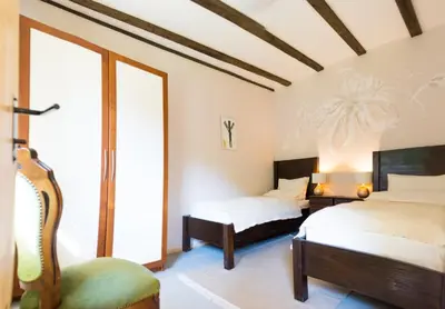 a bedroom with two beds and a window at Стаи за гости в Ритрийт Център 