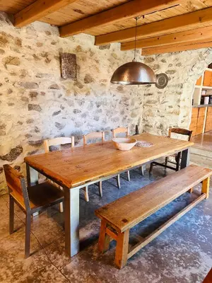 a wooden table and benches in a room at Подковите in Karlovo