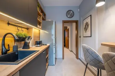 a kitchen with a sink and a refrigerator at Calm, Luxury Apartment, Premium Location at NDK! in Sofia