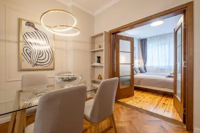 a dining room with a glass table and a bedroom at Calm, Luxury Apartment, Premium Location at NDK! in Sofia