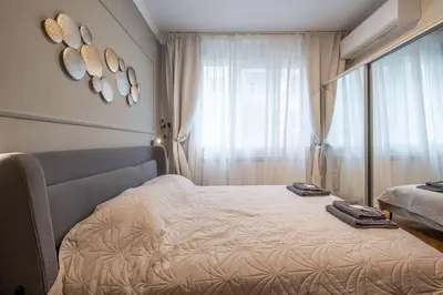 a bedroom with a bed with two towels on it at Calm, Luxury Apartment, Premium Location at NDK! in Sofia