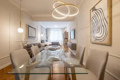 a dining room with a glass table and chairs at Calm, Luxury Apartment, Premium Location at NDK! in Sofia