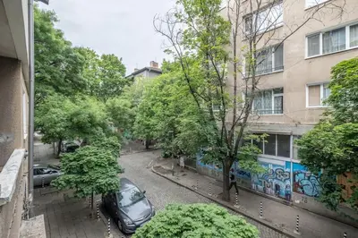 a street with a car parked in front of a building at Calm, Luxury Apartment, Premium Location at NDK! in Sofia