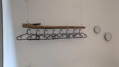 a black iron hanging rack on a white wall at 65 Duck House in Sofia