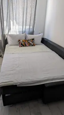 a bed with two pillows on it in a bedroom at 65 Duck House in Sofia